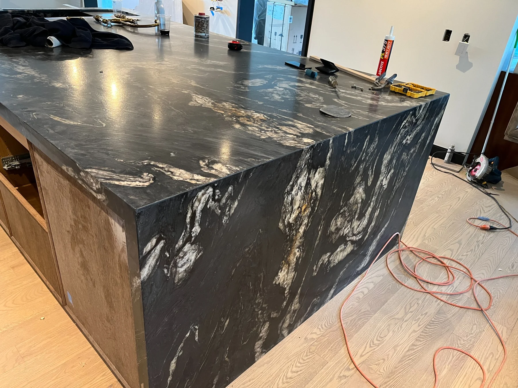 Belvedere Quartzite waterfall island with dramatic natural movement and mitered panels