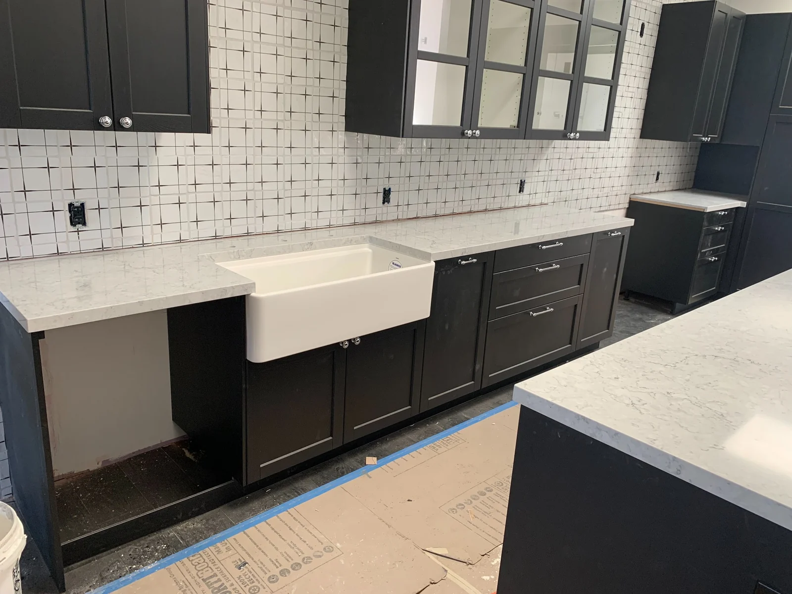 Caesarstone kitchen countertop with farmhouse sink and black cabinetry