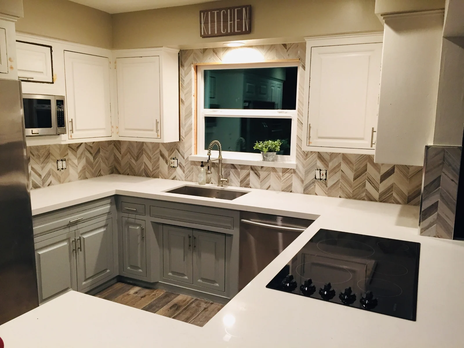 Caesarstone white kitchen countertops with farmhouse sink and herringbone backsplash