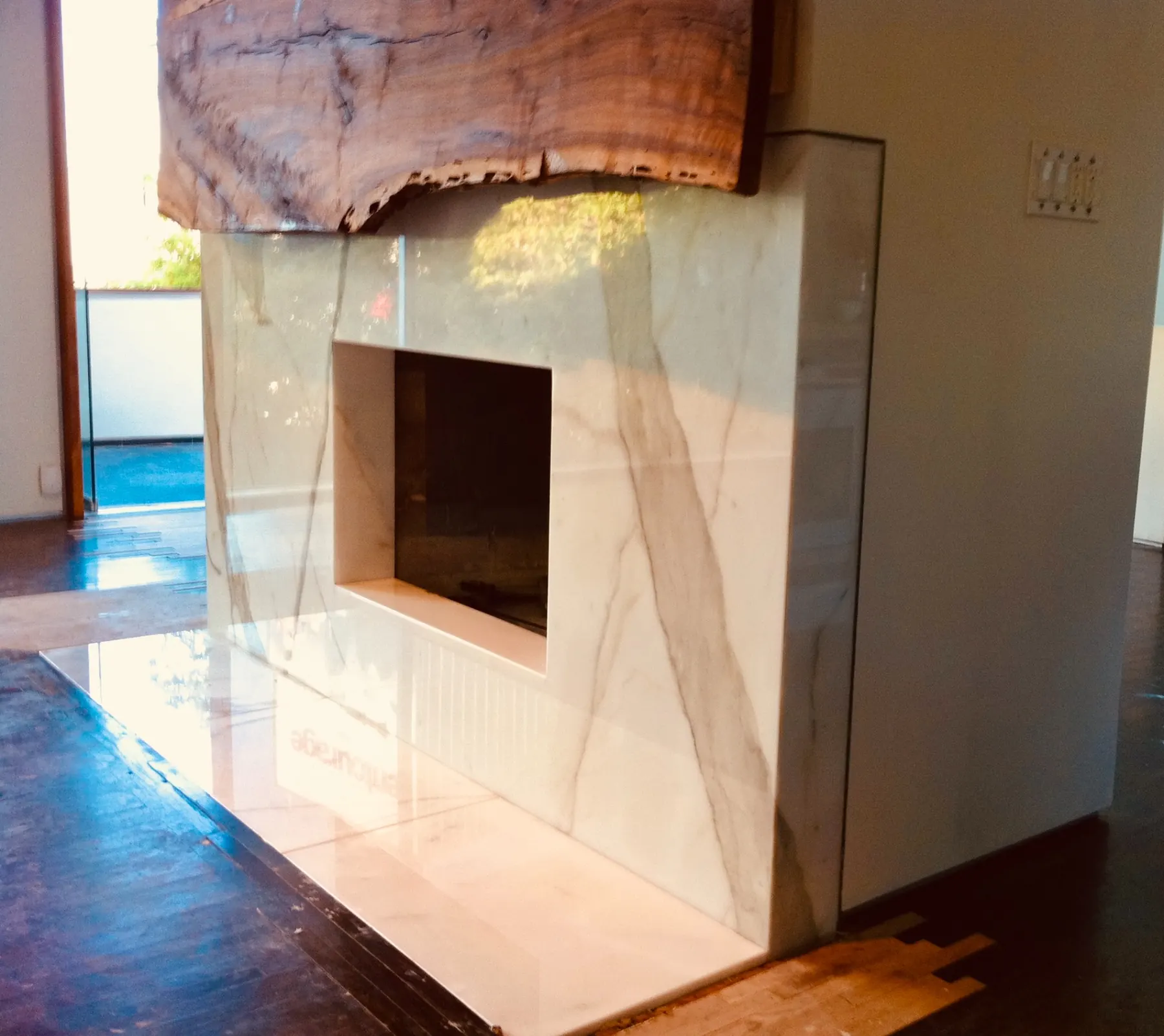 Finished custom stone fireplace with wood mantel