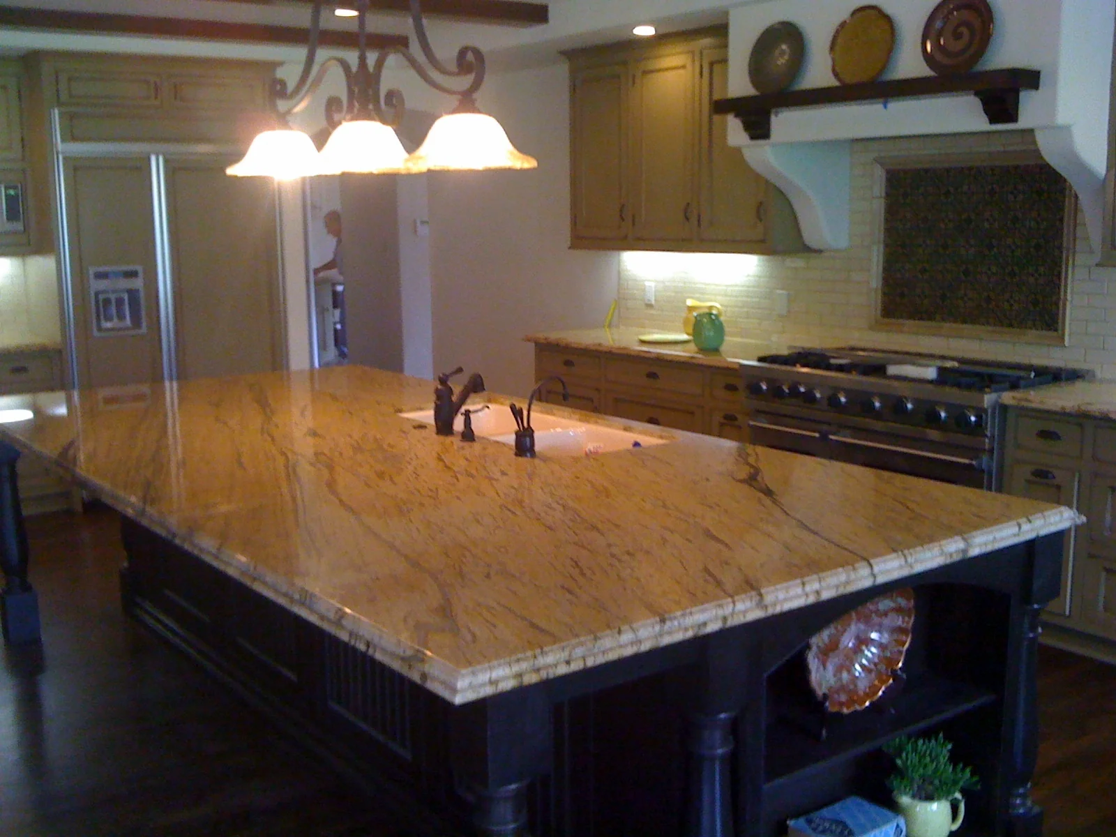 Wide view of a granite kitchen island with Ogee-bullnose edge detail and matching perimeter countertops