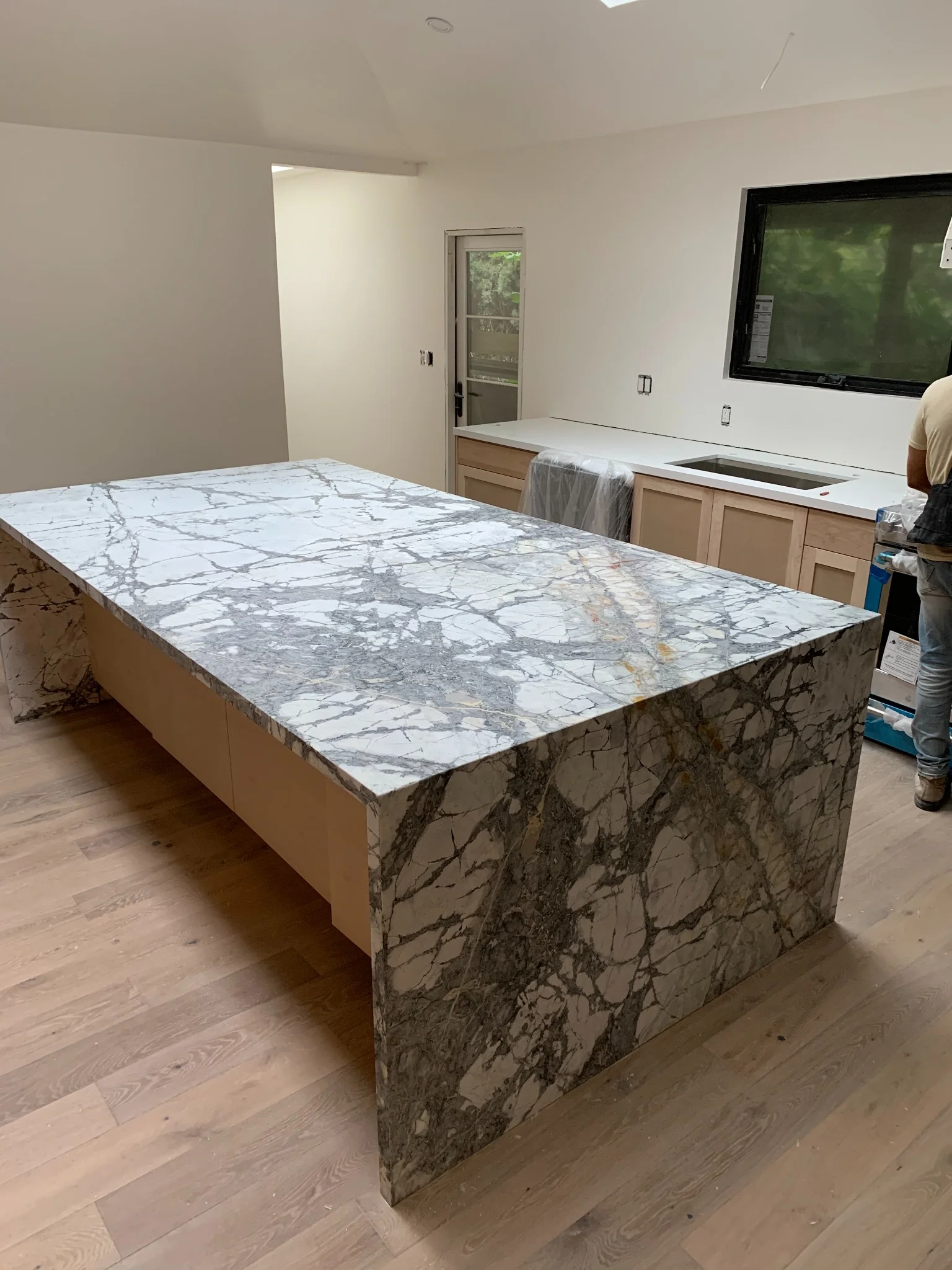 Side view of a grey veined marble waterfall island