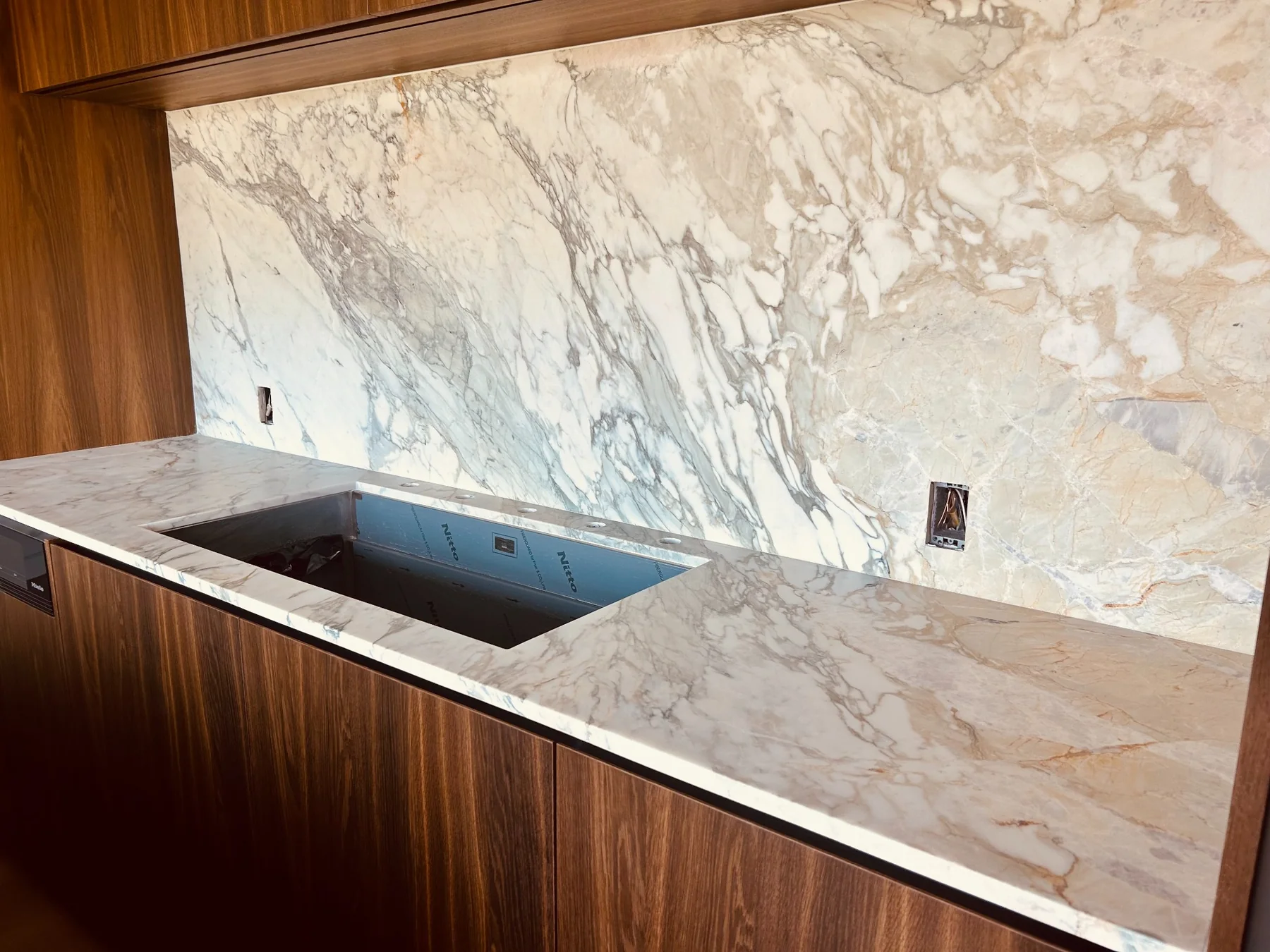 Calacatta Gold backsplash and matching bar countertop installation