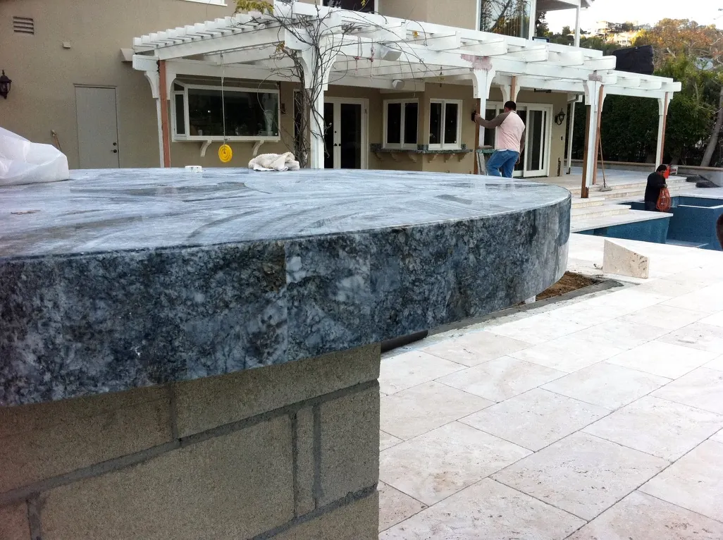 Round blue stone outdoor countertop detail near pool area