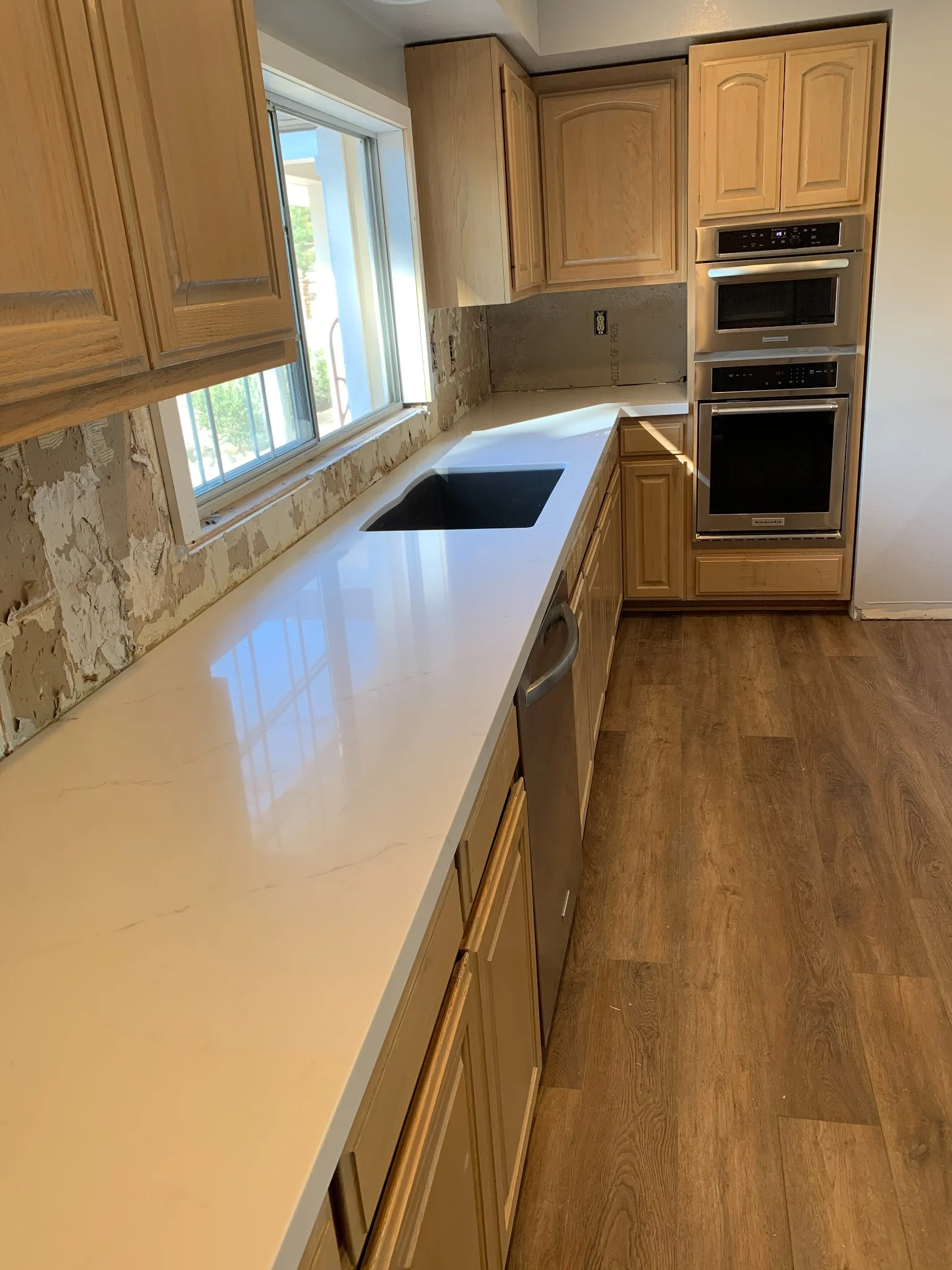 Pental Quartz white kitchen countertop with undermount sink and long counter run