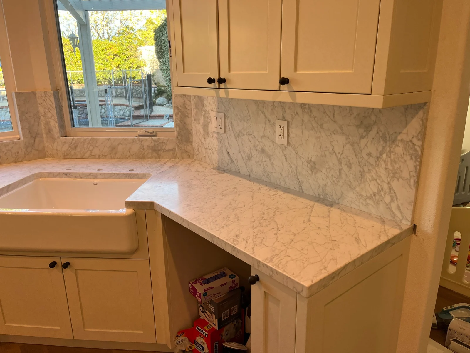 Bianco Carrara countertop and backsplash around a farmhouse sink