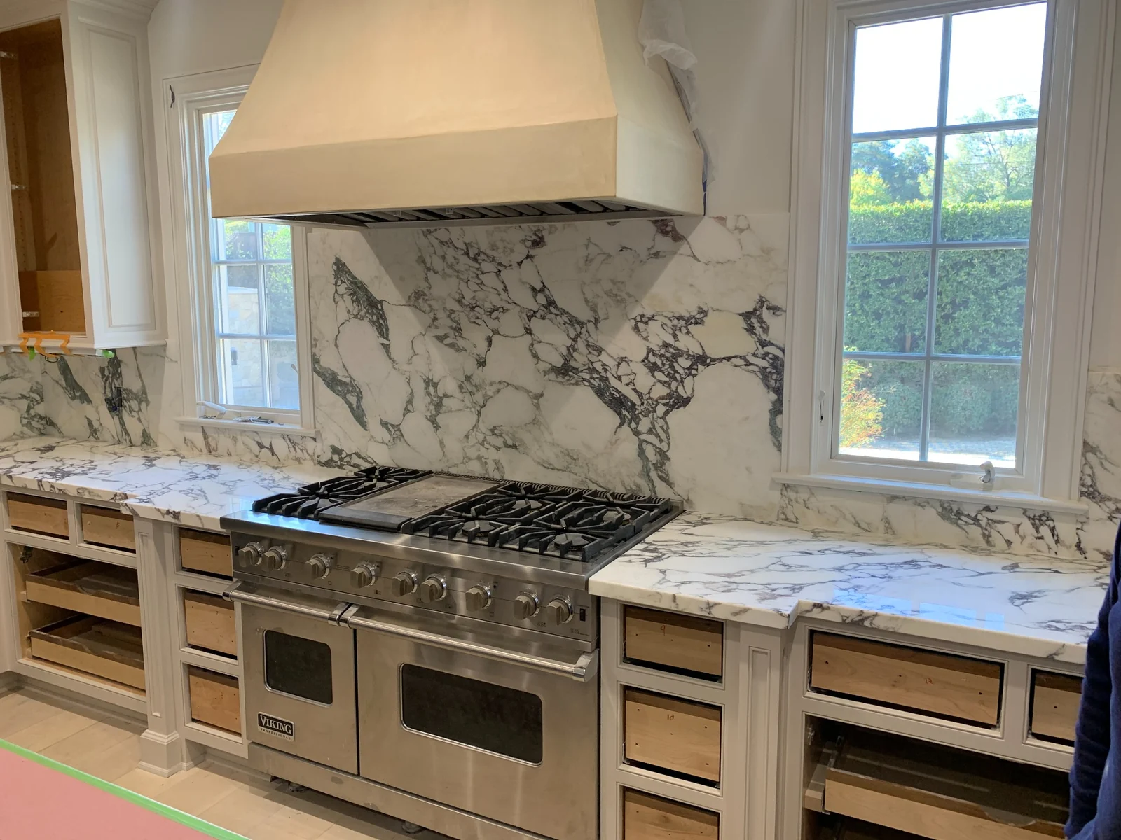 Calacatta Vagli statement backsplash behind a professional kitchen range