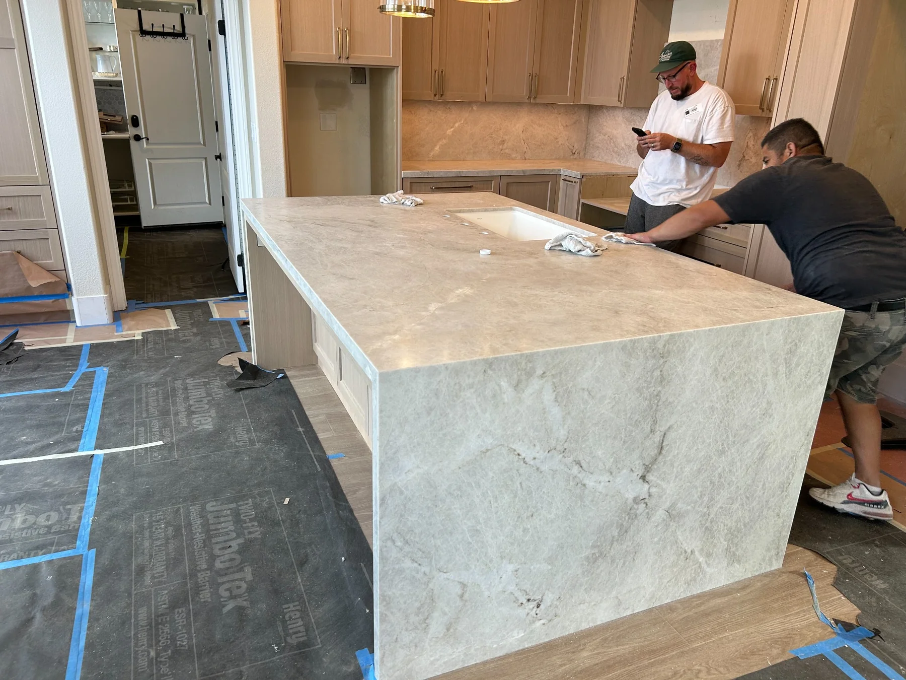 Taj Mahal quartzite kitchen island with mitered waterfall side panel