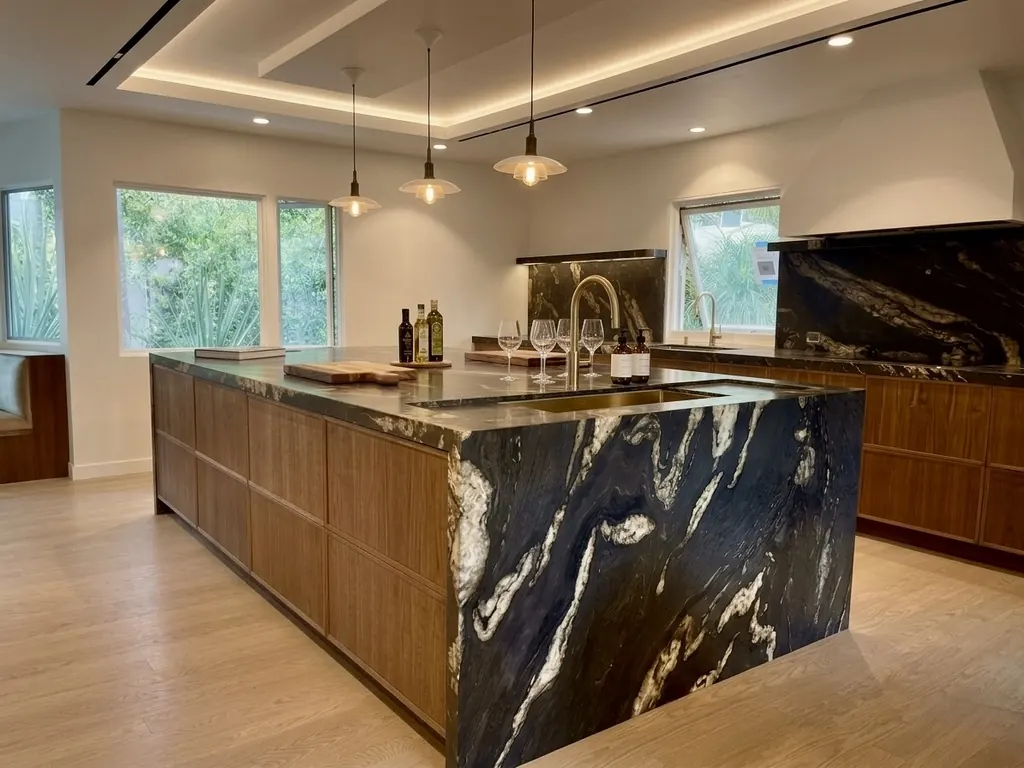 Finished dramatic black stone waterfall island in a Los Angeles kitchen
