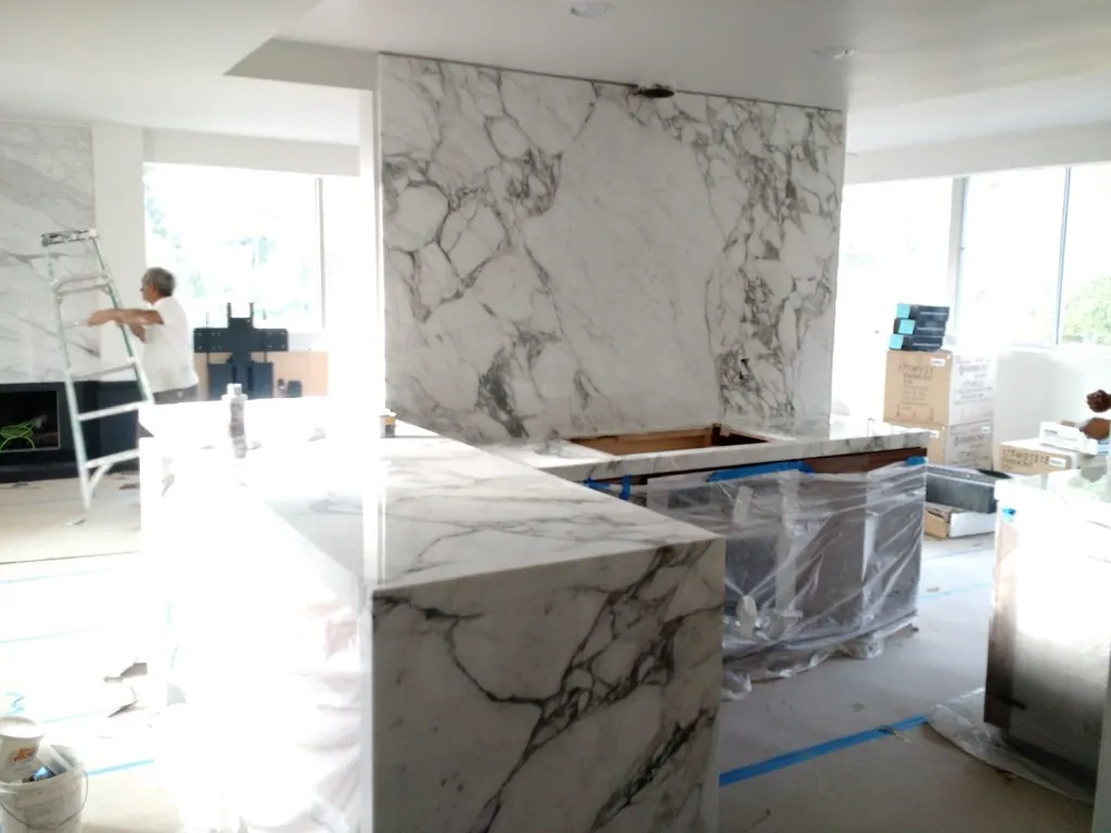 Custom marble waterfall island and backsplash installation in progress