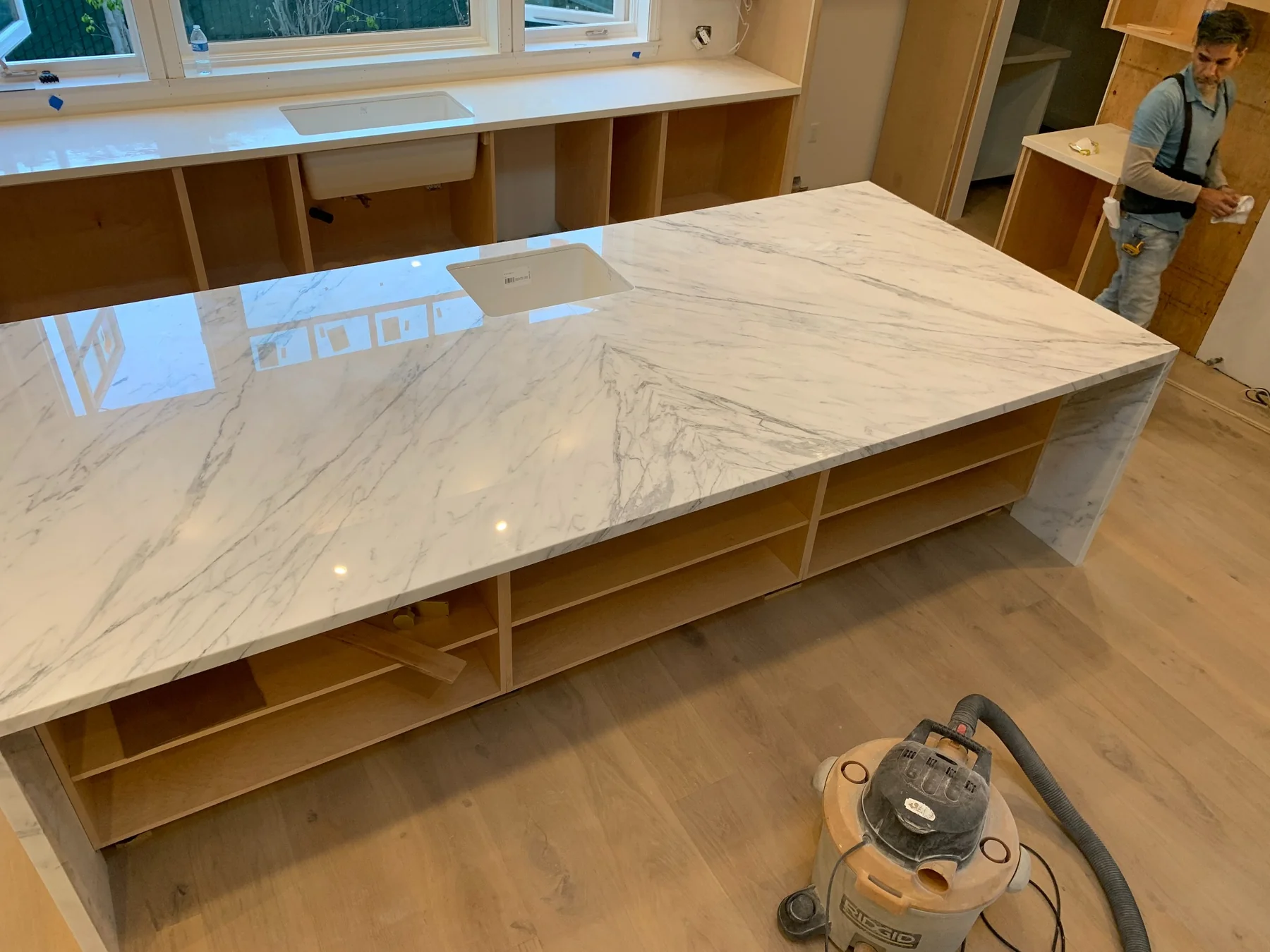 White marble island with integrated sink viewed from above