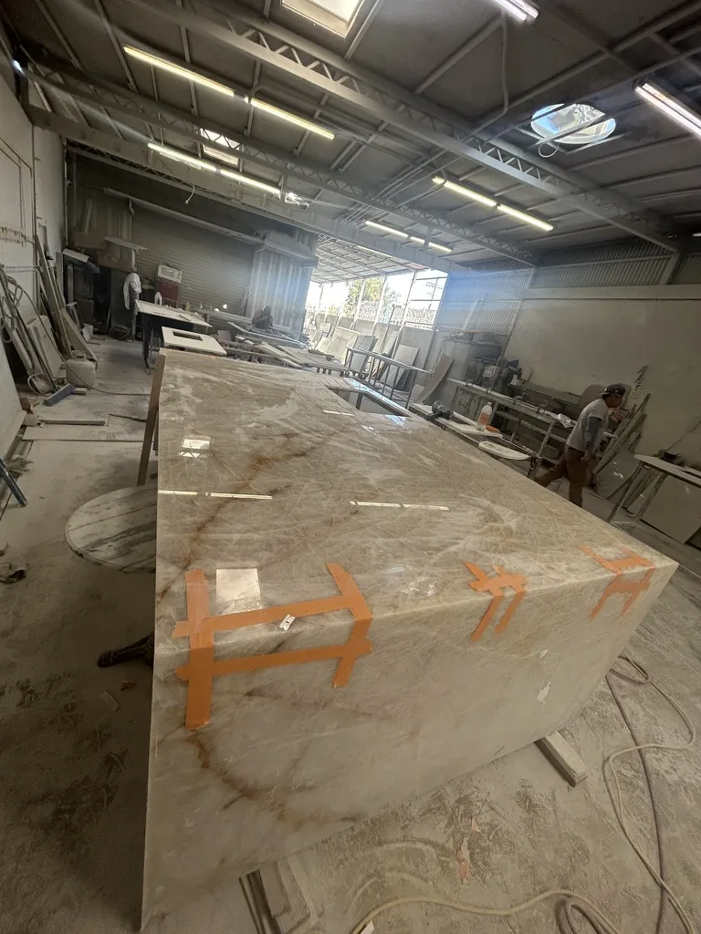 Direct stone fabricator preparing large-format slab for custom residential stone project in Los Angeles